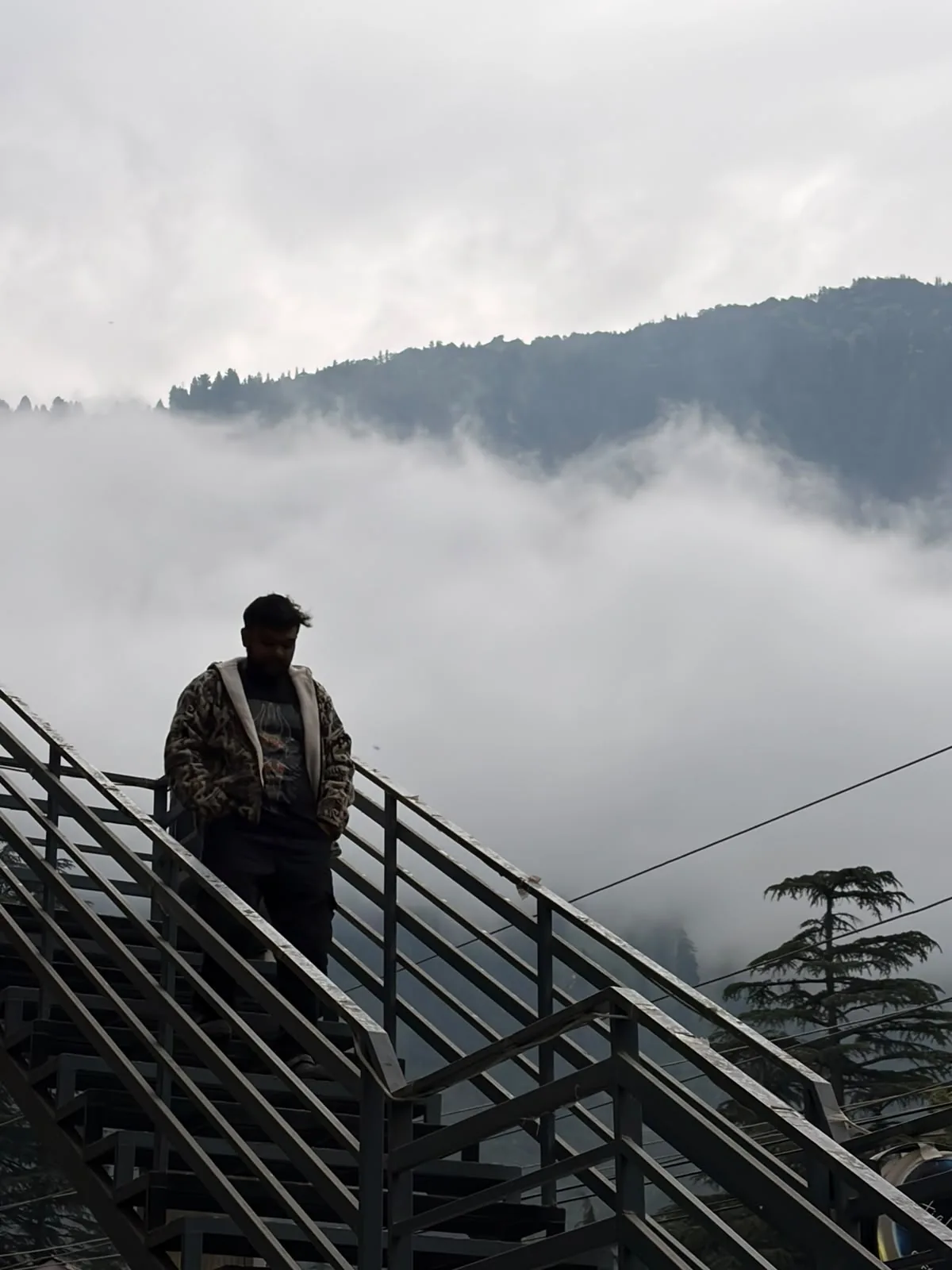 A family traveller looking across misty mountains