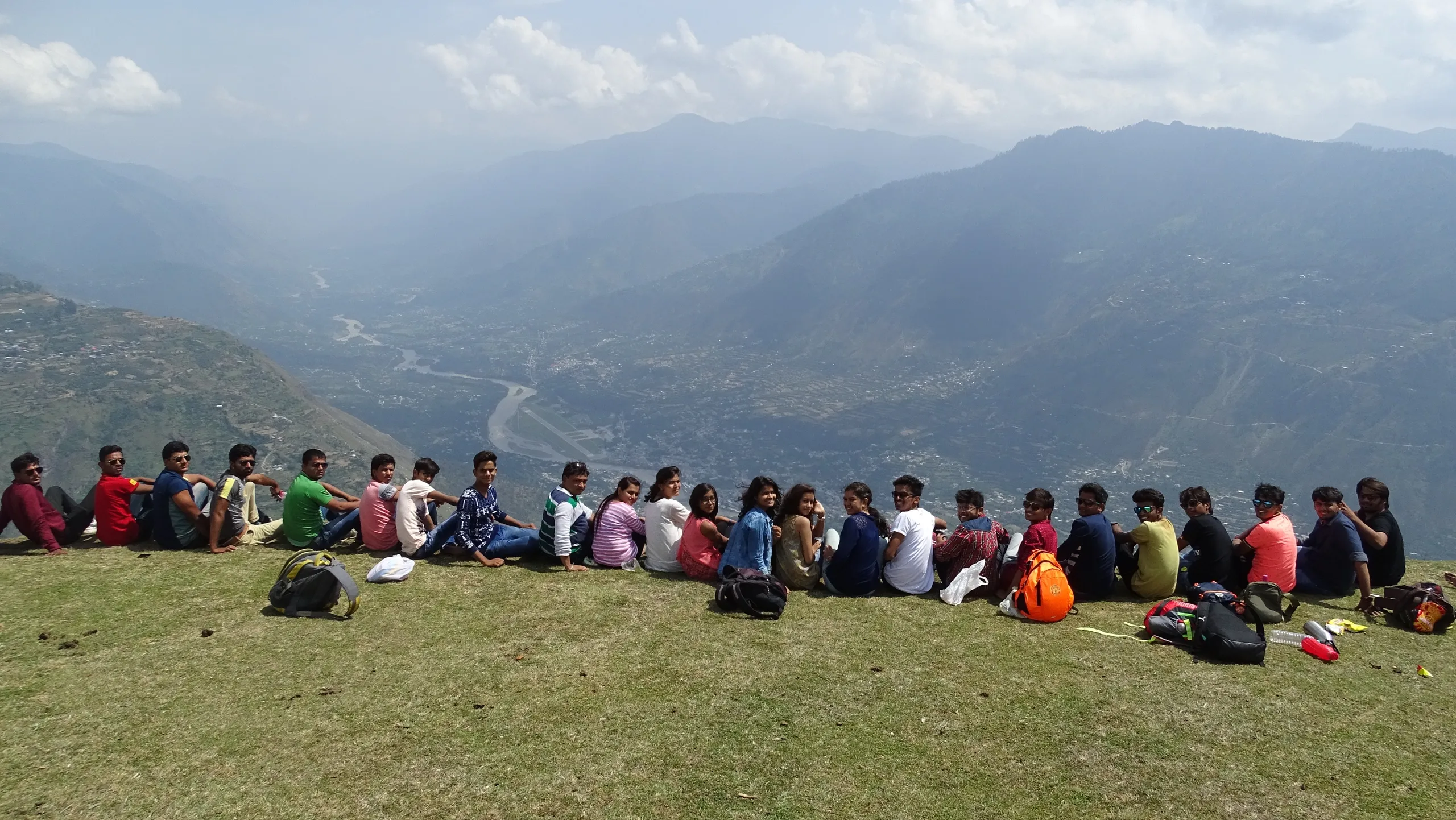 A Wings and Wheels group seated above a Himalayan valley