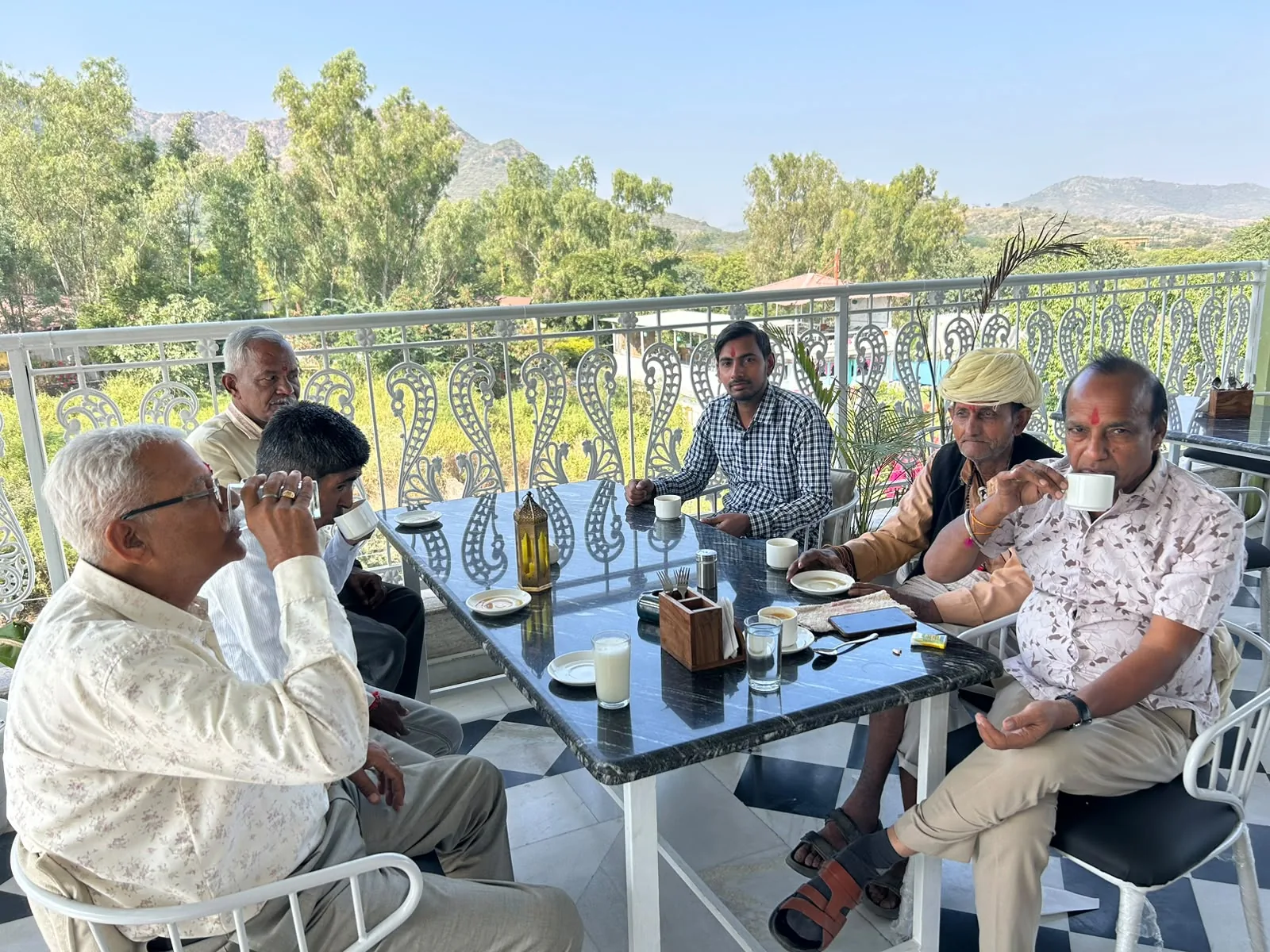 A travel group seated together outdoors
