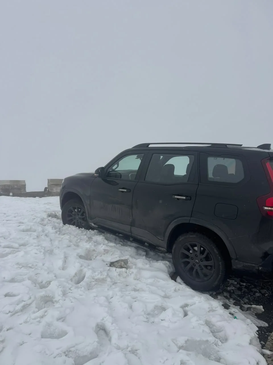 A vehicle travelling through deep snow
