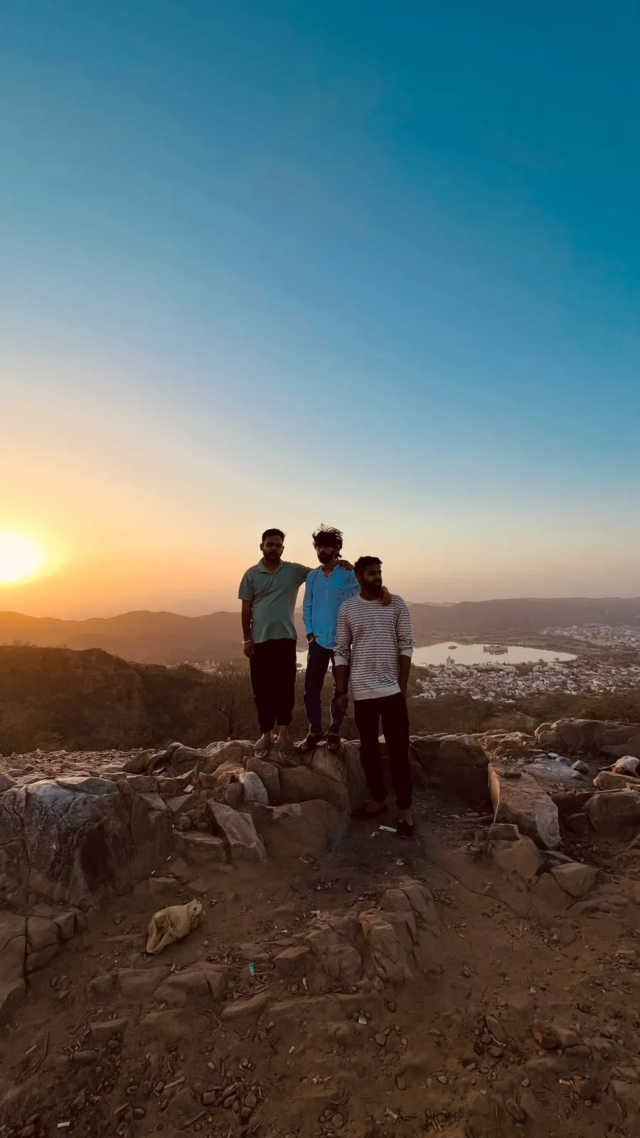Friends watching sunset from a hilltop
