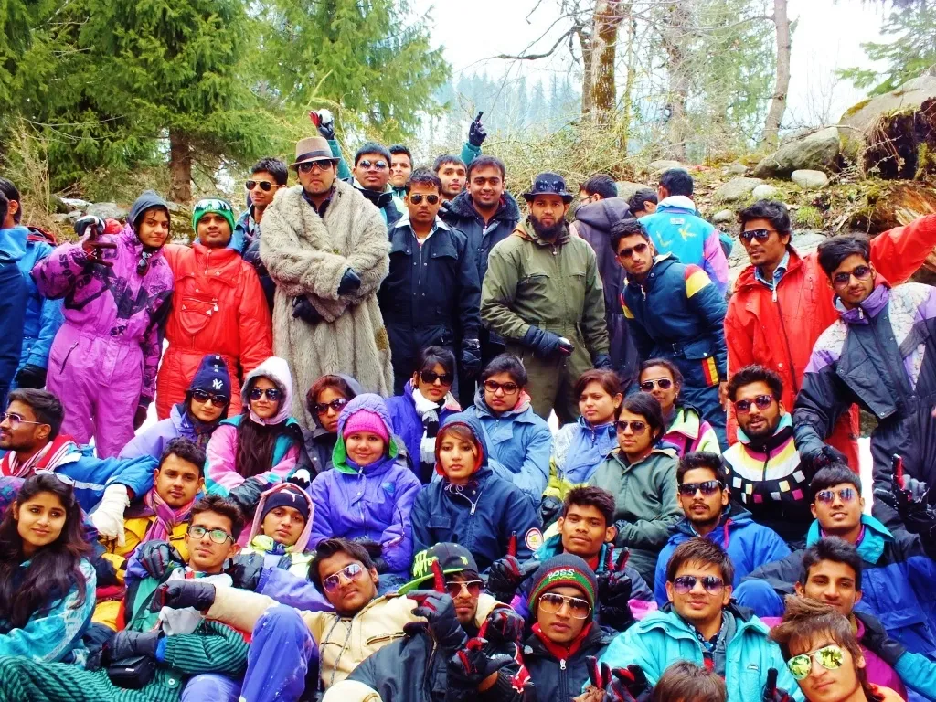 A large Wings and Wheels travel group together in snowy mountain clothing